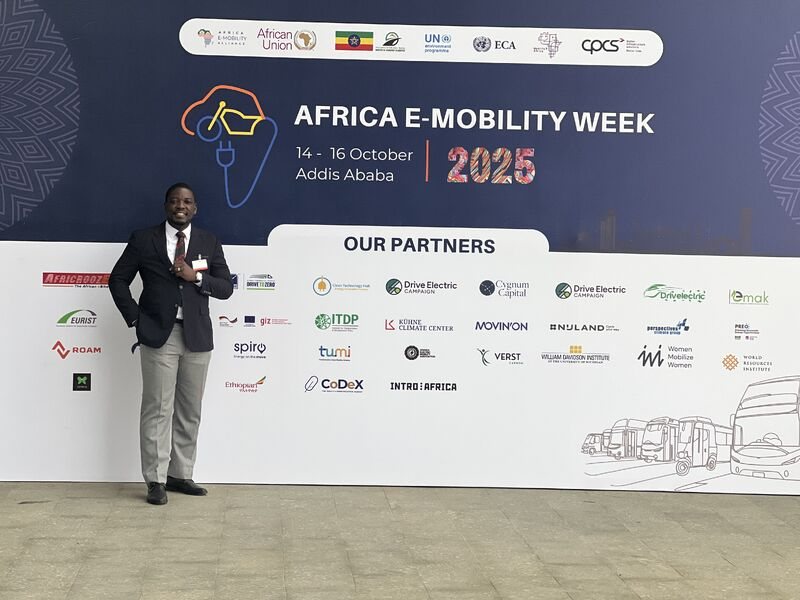 In front of the AEW2025 partners wall
