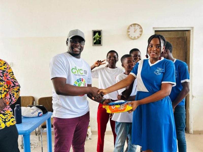 A pupil receives her class prize